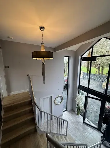 A freshly decorated landing and stairwell with painted walls and woodwork.